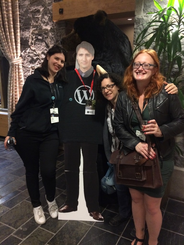Me and 2 colleagues with a cardboard cutout of Justin Trudeau and a bear in the background