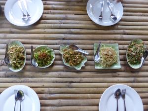 finished food laid out on table with plates and cutlery