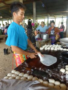 man frying many-layered bread