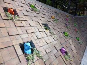colourful plastic groundhogs poking heads out of brick