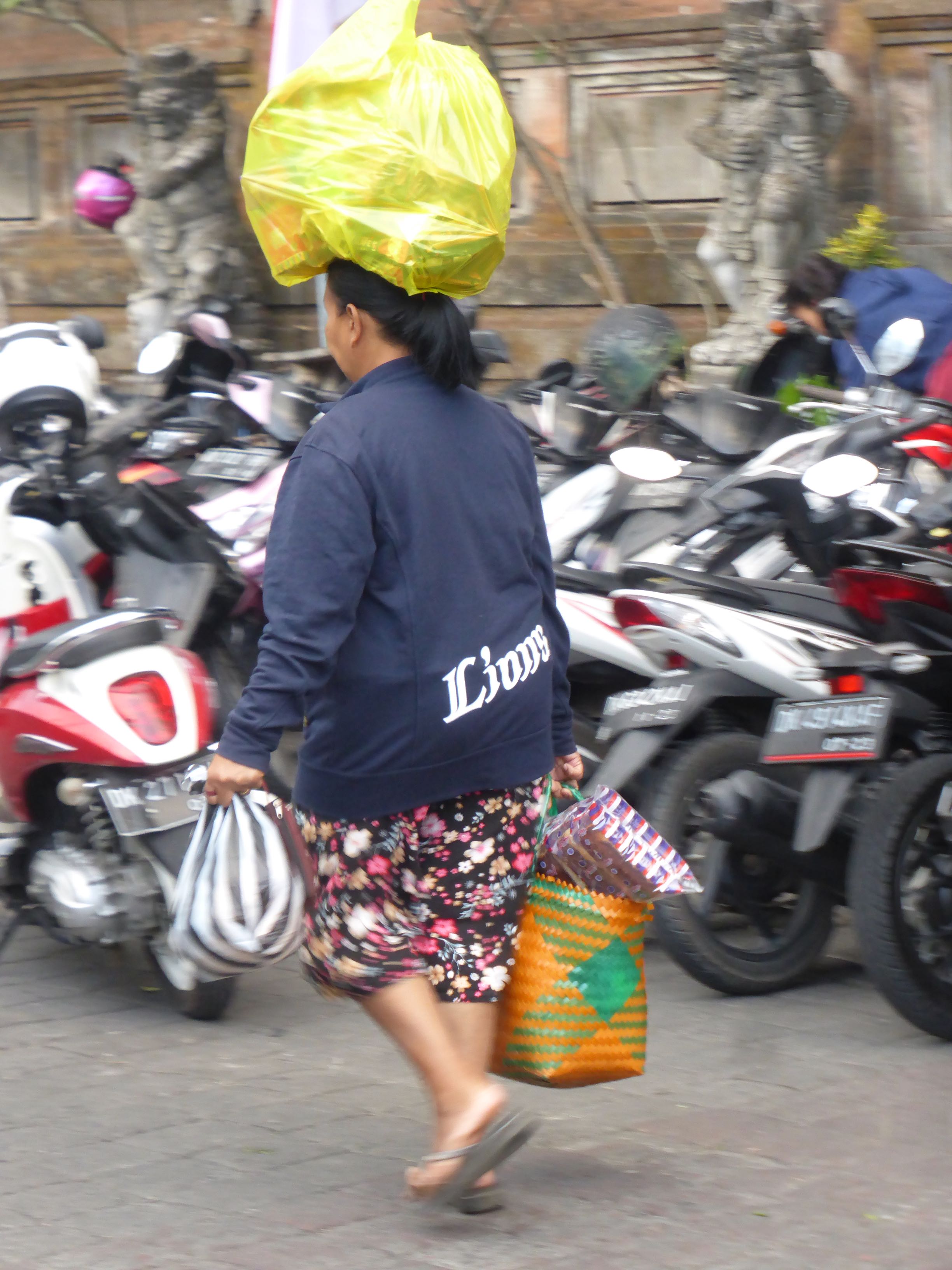 woman with yellow plastic bag on head