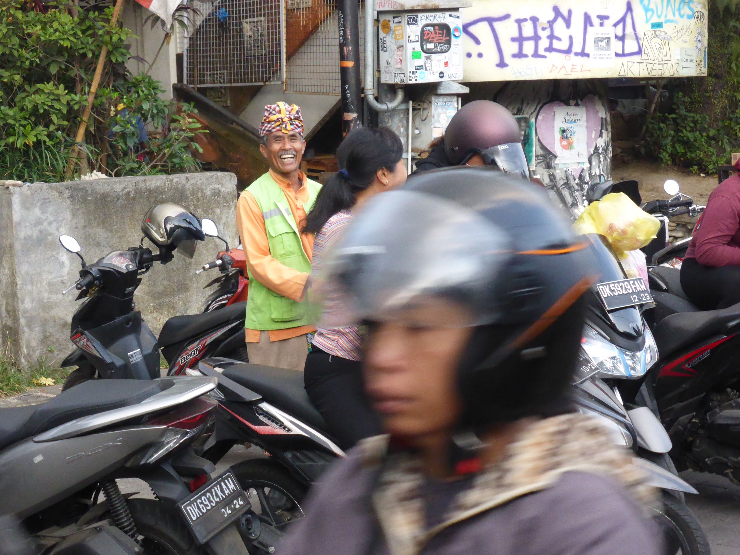 smiling man behind scooters