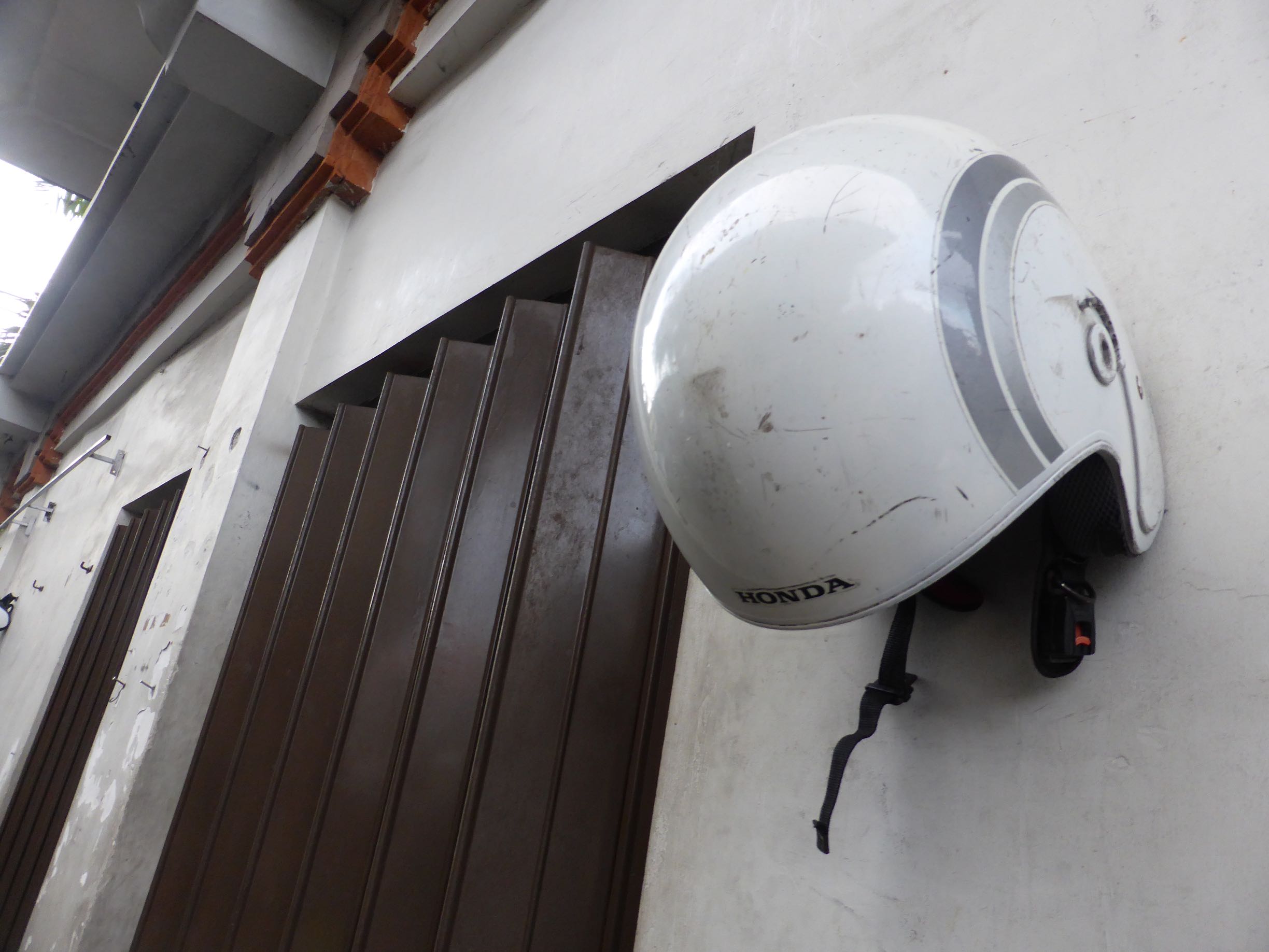 scooter helmet hanging on wall