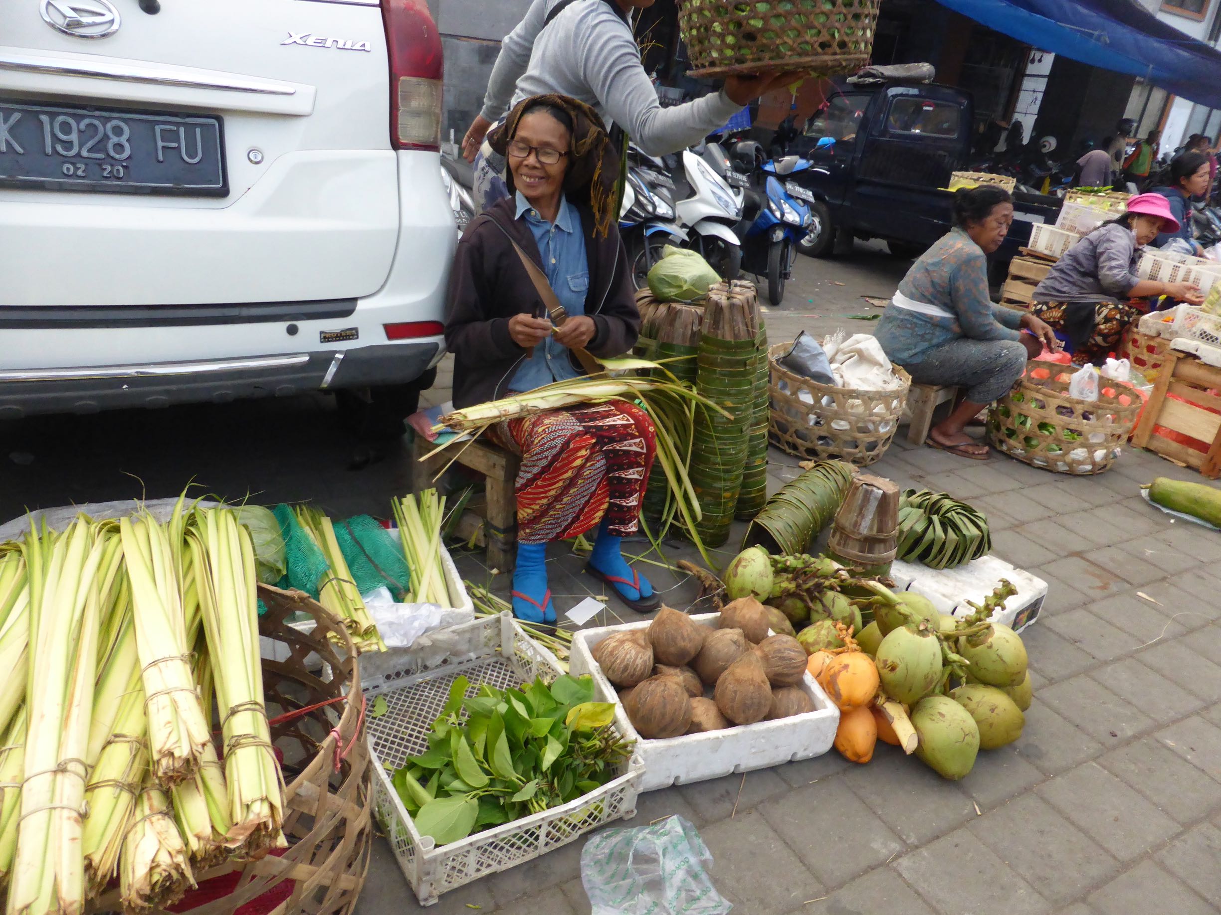 seller sitting behind produce
