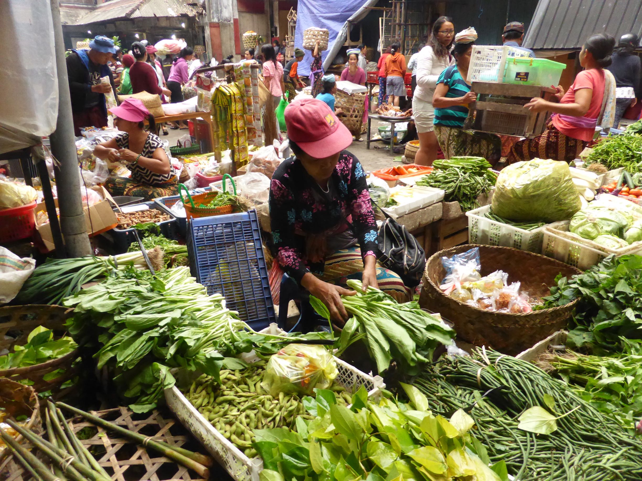 seller surrounded by produce