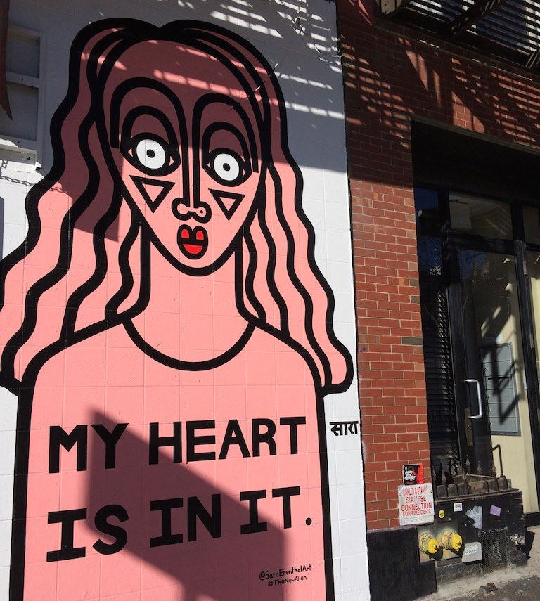 Street art on side of building - stylized person with "my heard is in it" written on their shirt