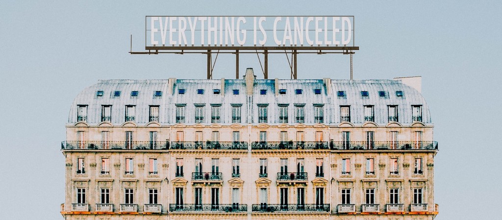 Sign on top of large building reads Everything Is Canceleld